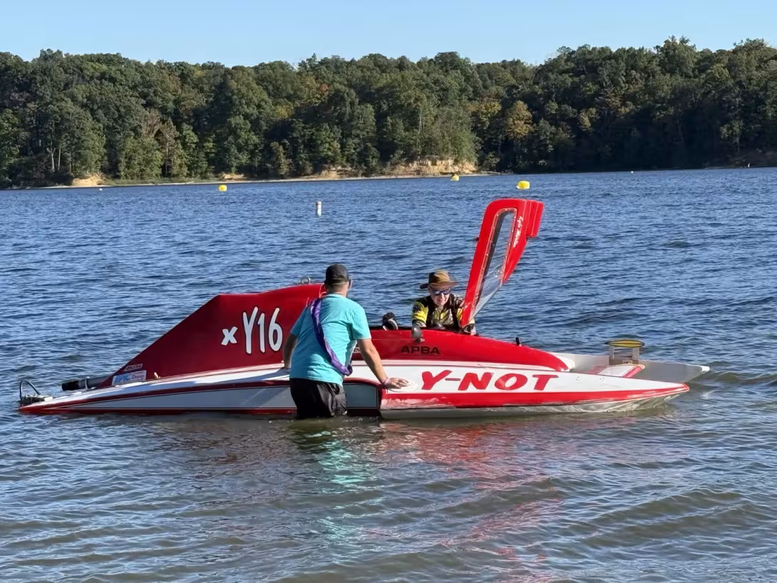 Y-16 with its canopy open and the team beside the boat at Hydrobowl